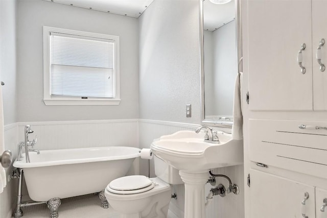7517 Saint Louis St, Austin, TX 78757 - full bath with a soaking tub, a wainscoted wall, and toilet