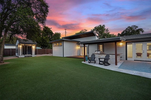 7517 Saint Louis St, Austin, TX 78757 - back of property featuring an outdoor structure and a patio area