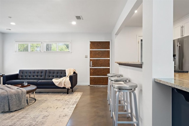 7517 Saint Louis St, Austin, TX 78757 - living room featuring finished concrete flooring and recessed lighting
