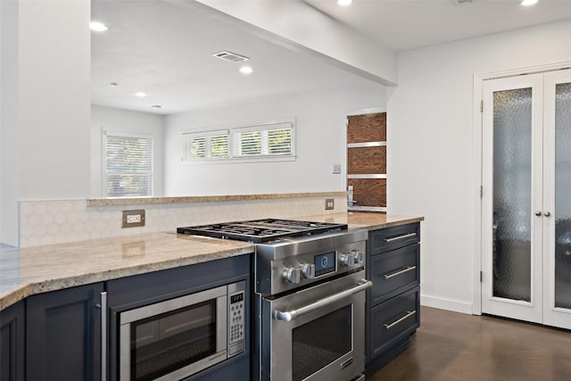 7517 Saint Louis St, Austin, TX 78757 - kitchen with french doors, stainless steel appliances, backsplash, light stone countertops, and recessed lighting