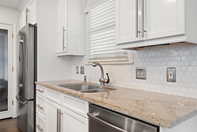 7517 Saint Louis St, Austin, TX 78757 - kitchen with appliances with stainless steel finishes, a sink, white cabinets, and tasteful backsplash