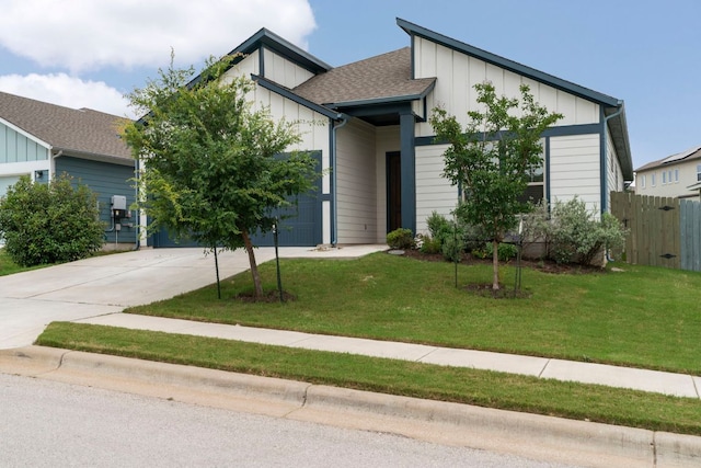 9904 Comely Bnd, Manor, TX 78653 - view of front of house with driveway, board and batten siding, an attached garage, and a shingled roof