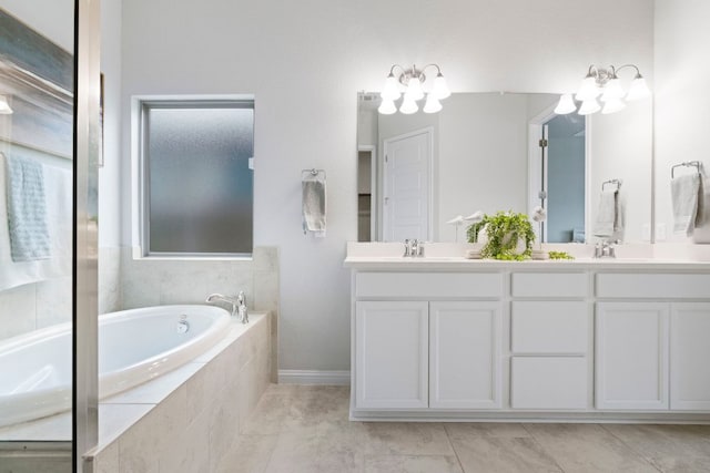 9904 Comely Bnd, Manor, TX 78653 - full bathroom with double vanity, a bath, and a chandelier