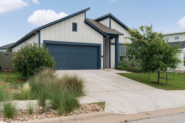 9904 Comely Bnd, Manor, TX 78653 - view of front of home with a garage, board and batten siding, concrete driveway, and roof with shingles