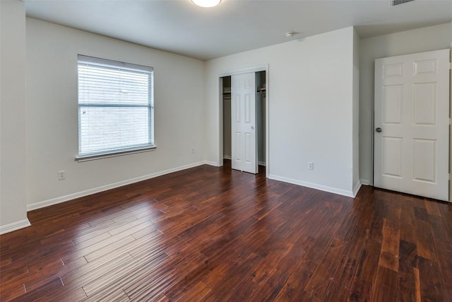 480 Middle Crk, Buda, TX 78610 - unfurnished bedroom with dark wood-type flooring, baseboards, and a closet