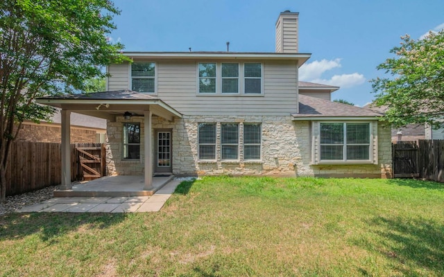 480 Middle Crk, Buda, TX 78610 - back of house with a patio, stone siding, a chimney, a ceiling fan, and roof with shingles