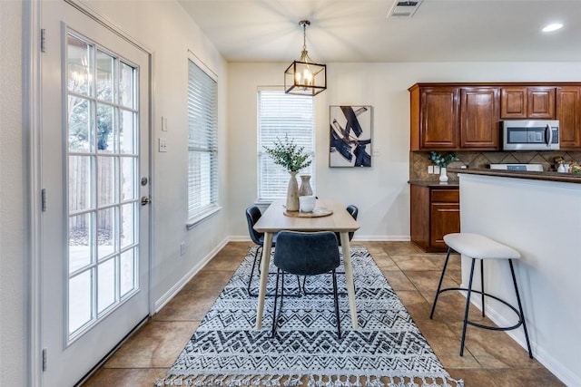 480 Middle Crk, Buda, TX 78610 - tiled dining space featuring a chandelier and baseboards