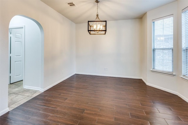 480 Middle Crk, Buda, TX 78610 - spare room with a chandelier, wood finished floors, arched walkways, and baseboards