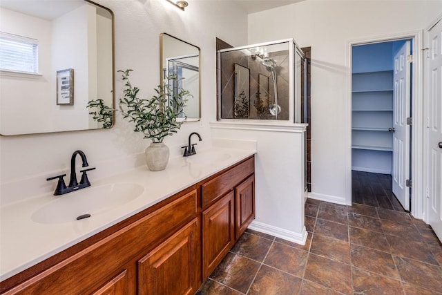 480 Middle Crk, Buda, TX 78610 - bathroom with double vanity, a shower stall, baseboards, and stone finish flooring