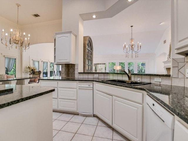 105 San Saba Ct, Horseshoe Bay, TX 78657 - kitchen featuring a chandelier, white dishwasher, a sink, backsplash, and white cabinetry