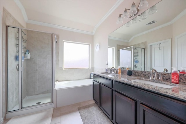 1317 Gaviota Ln, Leander, TX 78641 - bathroom featuring a shower stall, double vanity, crown molding, a bath, and tile patterned floors