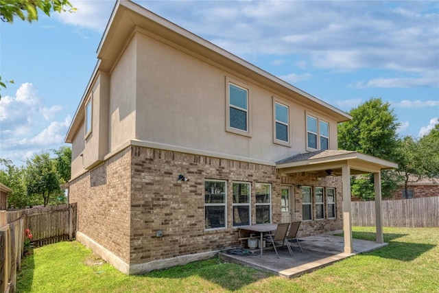 1317 Gaviota Ln, Leander, TX 78641 - back of house featuring a ceiling fan, brick siding, stucco siding, and a fenced backyard