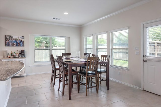 1317 Gaviota Ln, Leander, TX 78641 - dining room with healthy amount of natural light, crown molding, baseboards, and light tile patterned floors