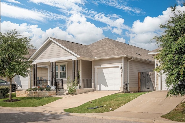 205 Michaelis Dr, Leander, TX 78641 - view of front of house featuring a garage, a porch, concrete driveway, and a gate