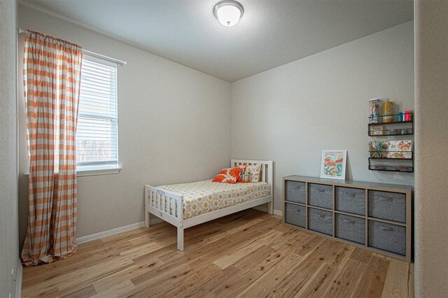 205 Michaelis Dr, Leander, TX 78641 - bedroom featuring wood finished floors, multiple windows, and baseboards