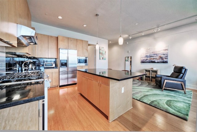 555 E 5th St Unit 809, Austin, TX 78701 - kitchen with appliances with stainless steel finishes, light brown cabinetry, range hood, light wood-type flooring, and recessed lighting