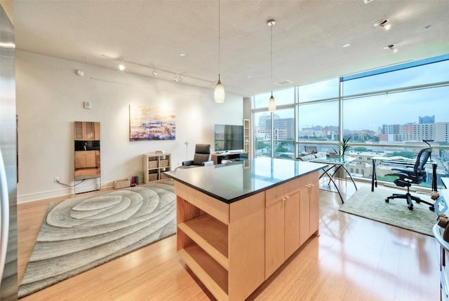 555 E 5th St Unit 809, Austin, TX 78701 - kitchen featuring open shelves, light wood-type flooring, a kitchen island, a wall of windows, and open floor plan