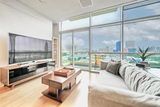 555 E 5th St Unit 809, Austin, TX 78701 - living area with a city view, floor to ceiling windows, wood finished floors, and plenty of natural light