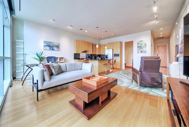 555 E 5th St Unit 809, Austin, TX 78701 - living room with light wood-style floors, recessed lighting, baseboards, and track lighting