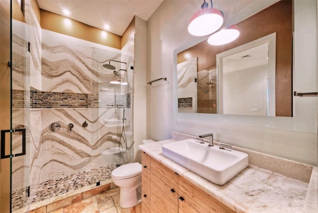 555 E 5th St Unit 809, Austin, TX 78701 - bathroom with vanity, a marble finish shower, and toilet