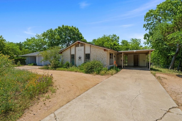 3105 Steck Ave, Austin, TX 78757 - view of front of property featuring driveway, an attached carport, and stone siding