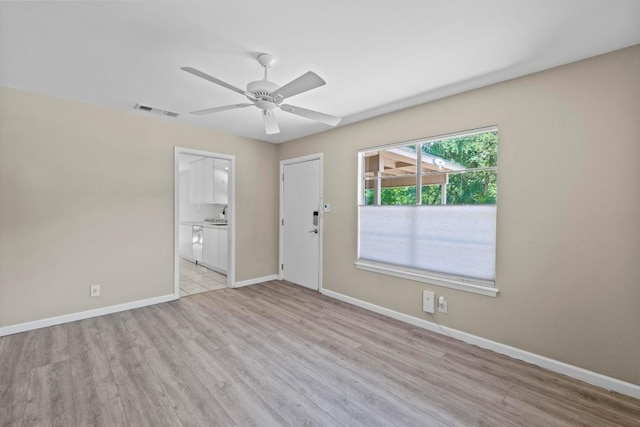 3105 Steck Ave, Austin, TX 78757 - spare room with light wood-style flooring, a ceiling fan, and baseboards