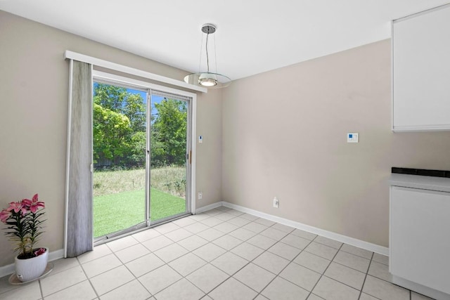 3105 Steck Ave, Austin, TX 78757 - unfurnished dining area featuring baseboards and light tile patterned floors