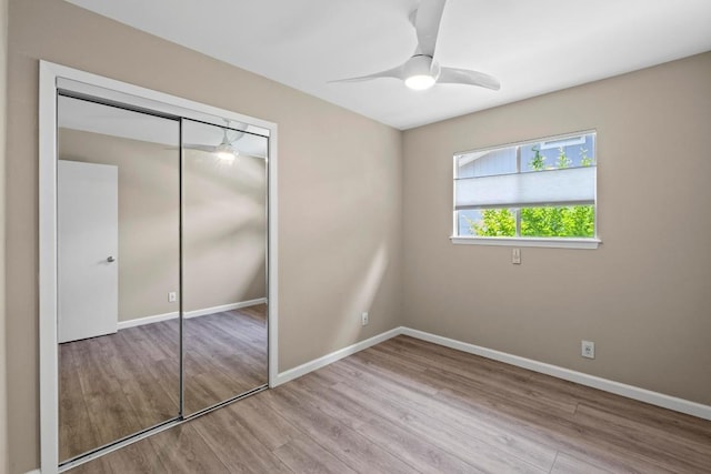 3105 Steck Ave, Austin, TX 78757 - unfurnished bedroom featuring wood finished floors, a closet, baseboards, and a ceiling fan