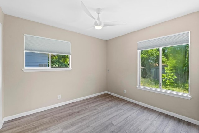 3105 Steck Ave, Austin, TX 78757 - spare room featuring baseboards, wood finished floors, and a ceiling fan