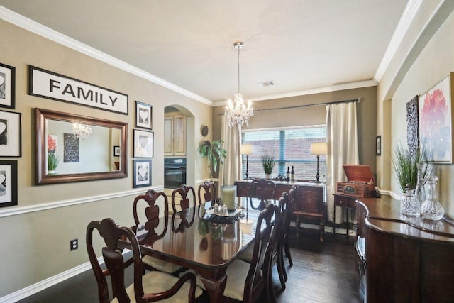 20737 Kearney Hill Rd, Pflugerville, TX 78660 - dining space with arched walkways, a chandelier, dark wood-type flooring, and crown molding