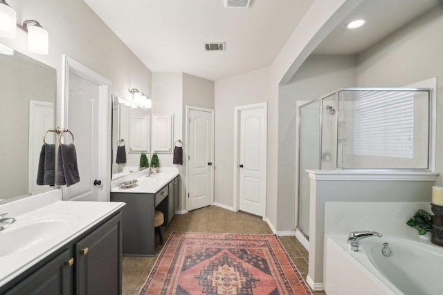 20737 Kearney Hill Rd, Pflugerville, TX 78660 - bathroom featuring a shower stall, two vanities, a bath, and tile patterned floors
