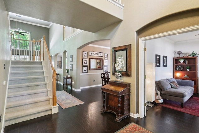 20737 Kearney Hill Rd, Pflugerville, TX 78660 - foyer entrance with arched walkways, hardwood / wood-style floors, ornamental molding, and stairs