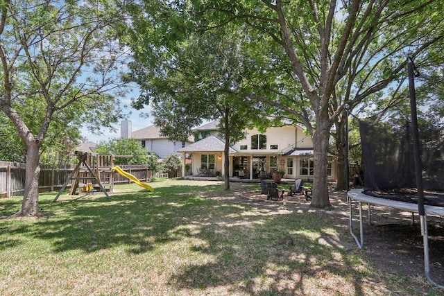 20737 Kearney Hill Rd, Pflugerville, TX 78660 - fenced backyard featuring a trampoline, a playground, and a patio