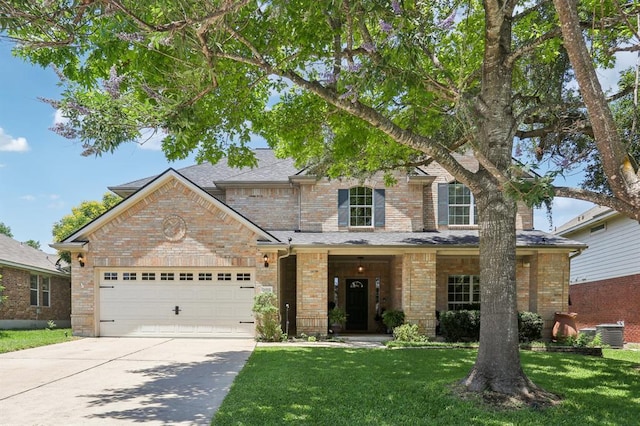 20737 Kearney Hill Rd, Pflugerville, TX 78660 - traditional-style home with an attached garage, driveway, a front yard, and brick siding