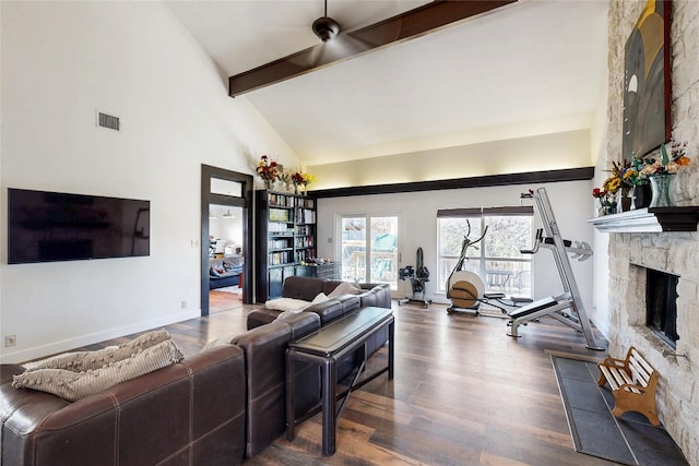 6002 Rain Creek Pkwy, Austin, TX 78759 - living area with beamed ceiling, dark wood-style flooring, high vaulted ceiling, a stone fireplace, and baseboards
