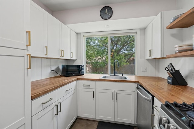 1514 Turtle Creek Blvd, Austin, TX 78745 - kitchen featuring butcher block counters, open shelves, a sink, and stainless steel appliances