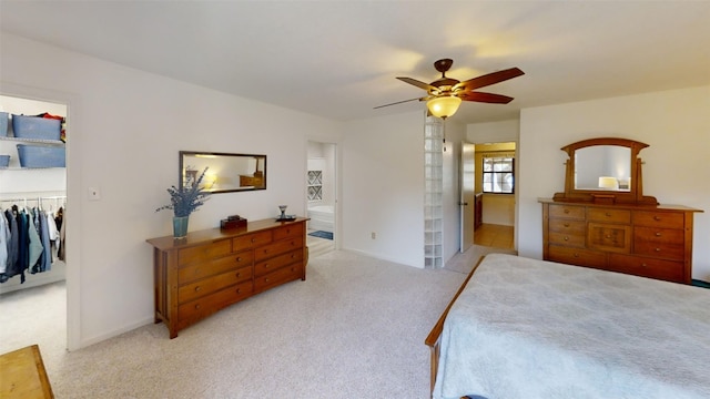 4006 Spanish Oak Ln, Dripping Springs, TX 78620 - bedroom with carpet flooring, a walk in closet, a closet, a ceiling fan, and baseboards