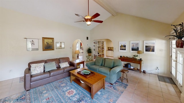 4006 Spanish Oak Ln, Dripping Springs, TX 78620 - living room featuring ceiling fan, beamed ceiling, light tile patterned flooring, arched walkways, and high vaulted ceiling