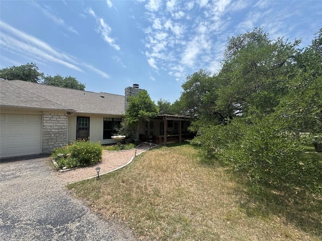 4006 Spanish Oak Ln, Dripping Springs, TX 78620 - view of grassy yard featuring an attached garage