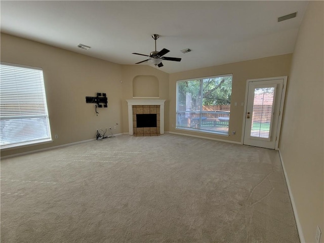 unfurnished living room featuring a ceiling fan, baseboards, vaulted ceiling, and light carpet