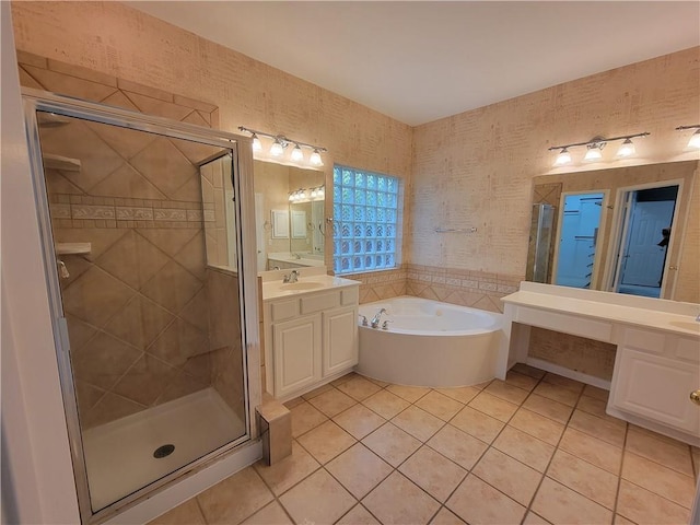 full bath featuring tile patterned floors, a garden tub, a stall shower, and vanity