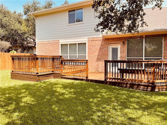 back of property featuring brick siding and a wooden deck