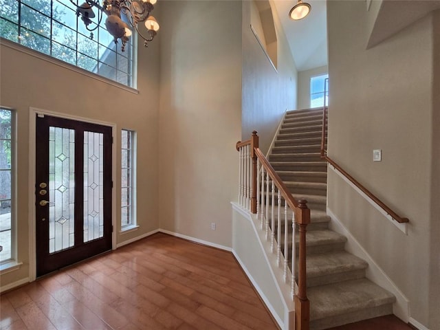 1411 Hunter Ace Way, Cedar Park, TX 78613 - foyer entrance with wood finished floors, a chandelier, stairway, and a towering ceiling