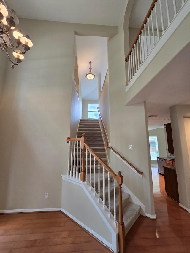 1411 Hunter Ace Way, Cedar Park, TX 78613 - stairway with wood finished floors, healthy amount of natural light, and a chandelier