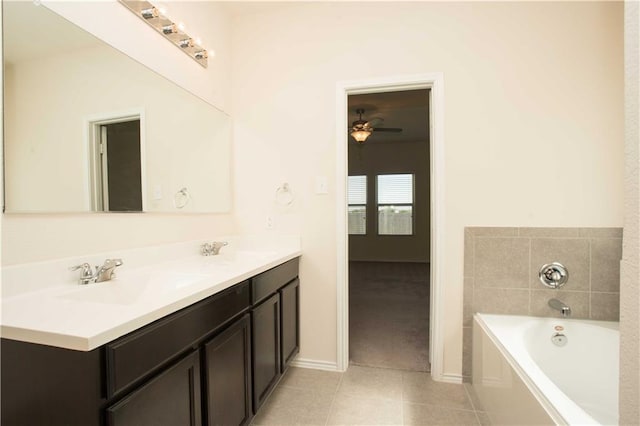 1036 Hillrose Dr, Leander, TX 78641 - bathroom featuring tile patterned flooring, a bath, double vanity, a ceiling fan, and baseboards