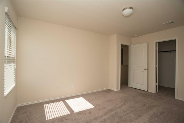 1036 Hillrose Dr, Leander, TX 78641 - unfurnished bedroom with carpet floors, a walk in closet, baseboards, and a closet