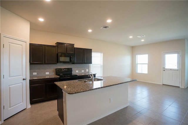 1036 Hillrose Dr, Leander, TX 78641 - kitchen with black appliances, a sink, dark stone countertops, decorative backsplash, and plenty of natural light