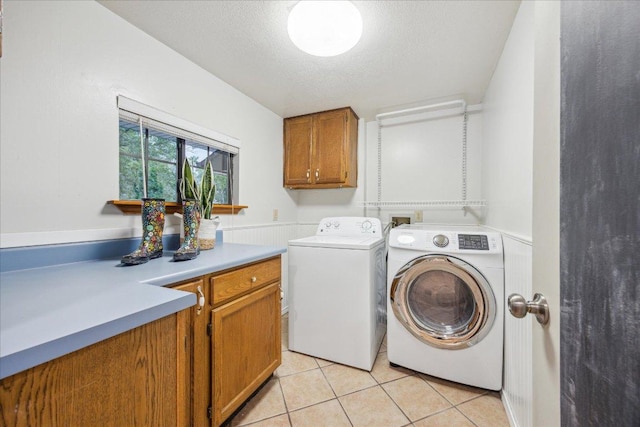 11900 Tunnel Trl, Manchaca, TX 78652 - laundry area featuring separate washer and dryer, light tile patterned flooring, cabinet space, and a textured ceiling