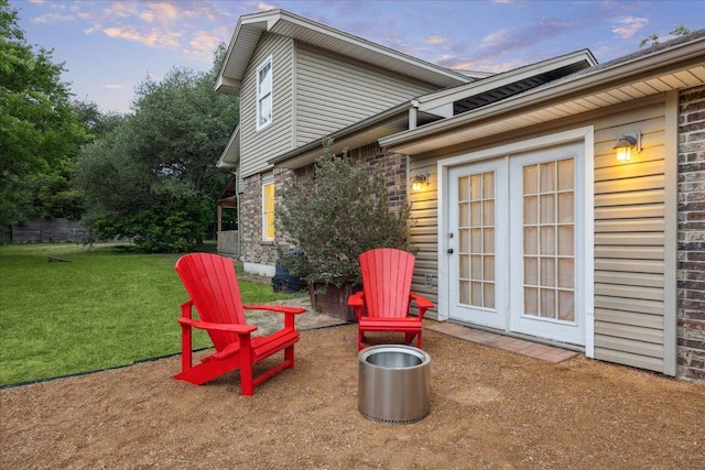 11900 Tunnel Trl, Manchaca, TX 78652 - back of house at dusk with a lawn and brick siding
