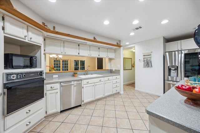 11900 Tunnel Trl, Manchaca, TX 78652 - kitchen featuring black appliances, a sink, white cabinetry, light tile patterned floors, and recessed lighting